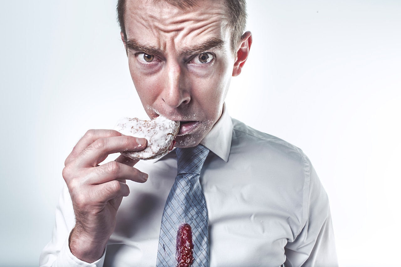 Overblown head of man whilst eating